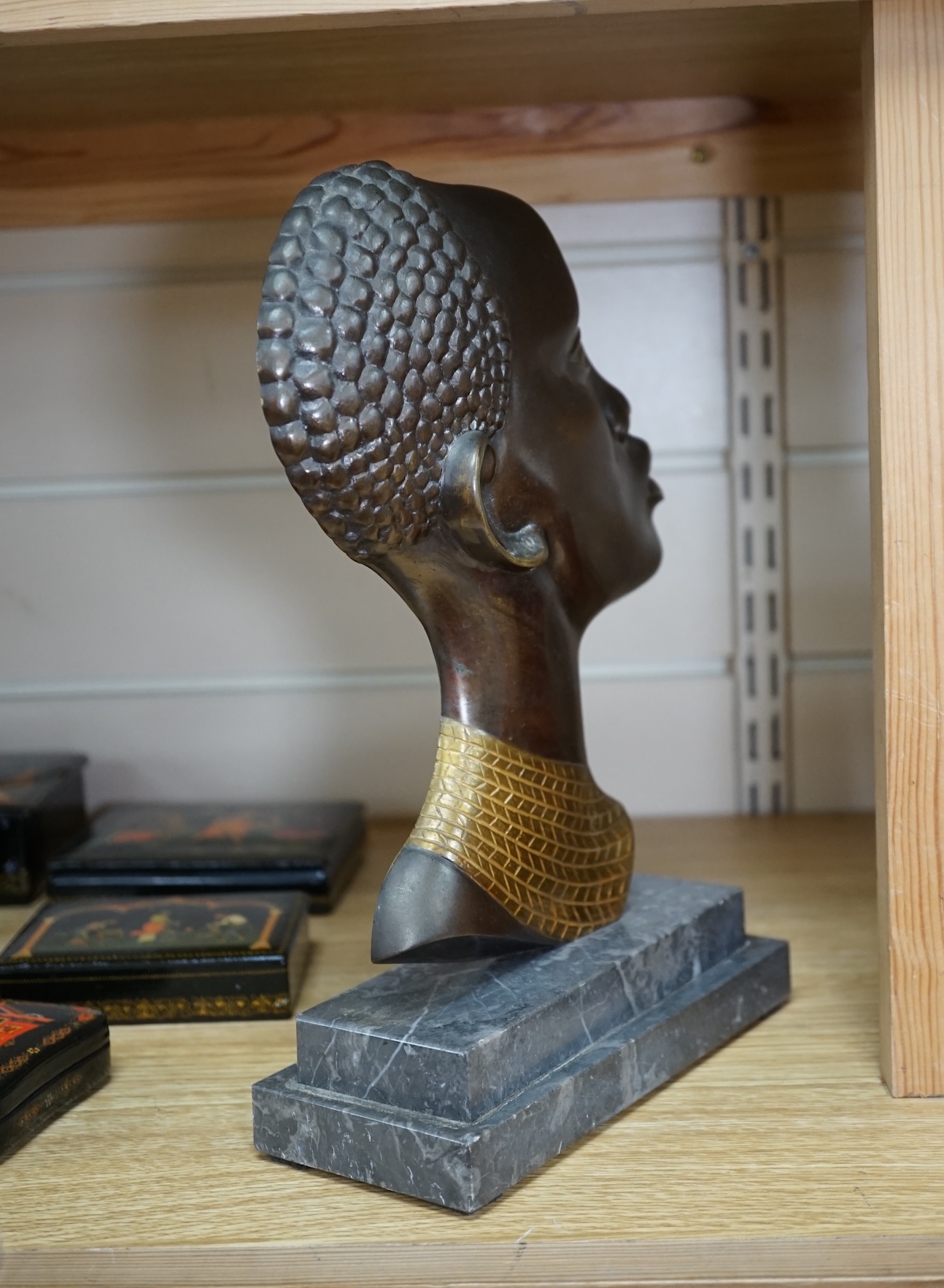 An Art Deco Hagenauer style bronze study of an African lady, stepped marble base, 28cm. Condition - earring missing